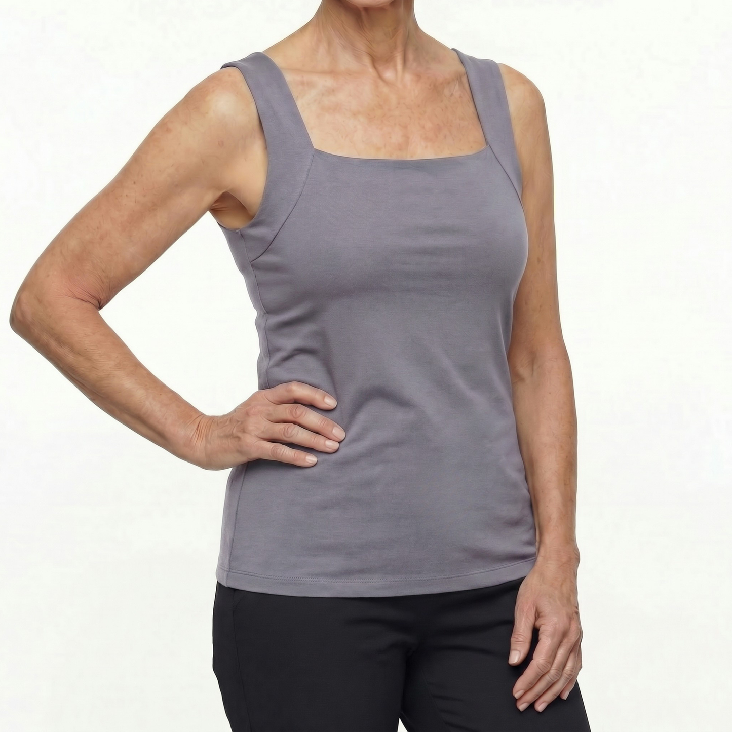 Person wearing a gray tank top on a white background