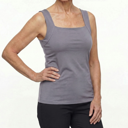 Person wearing a gray tank top on a white background