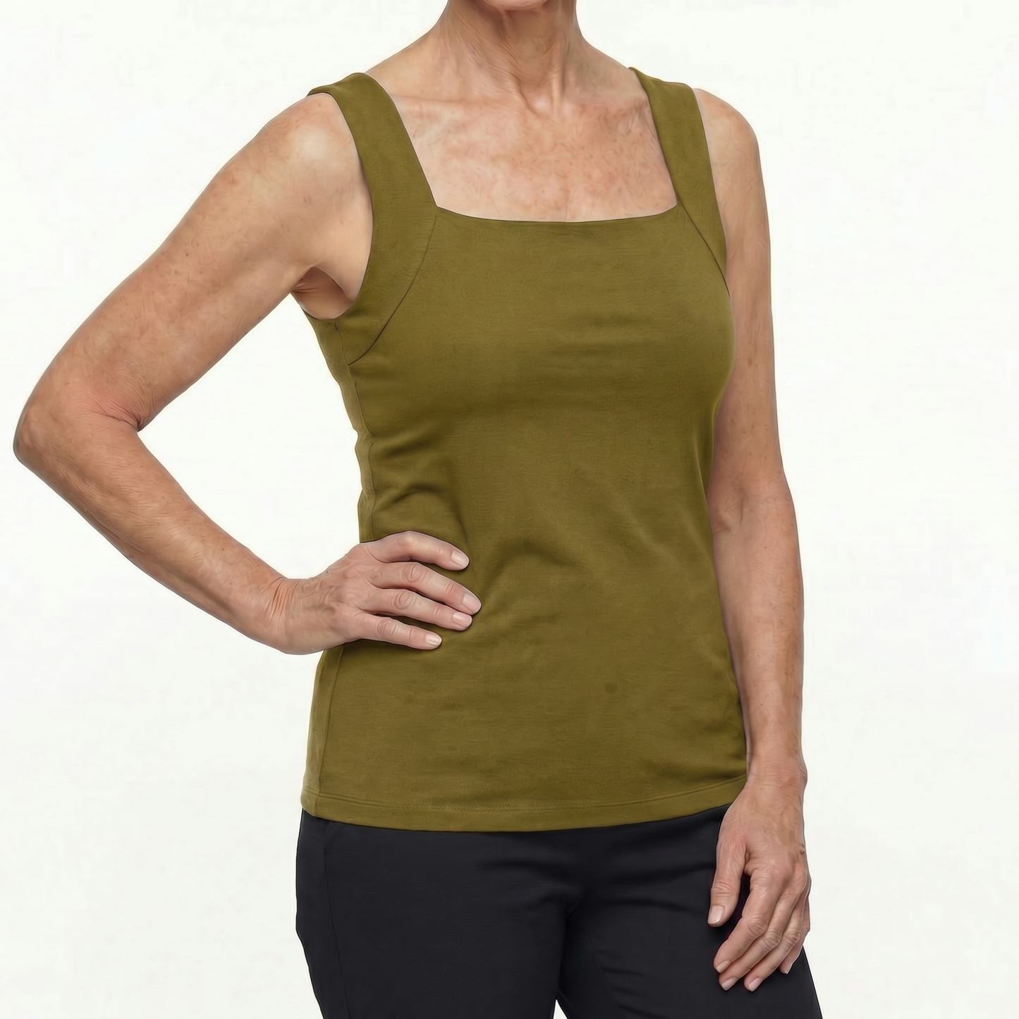 Person wearing a green tank top on a white background