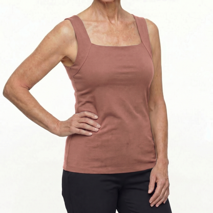 Woman wearing a mauve tank top on a white background